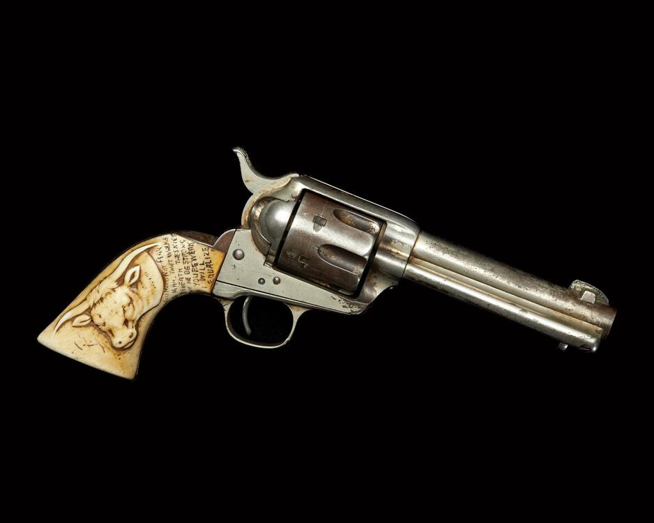 Colt .45 revolver with ivory handle with a carved image of a steer